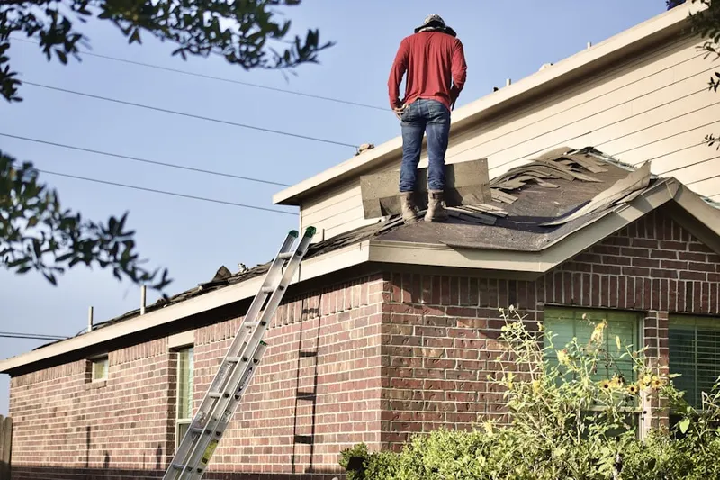 Professional roofer working on a residential roof in Woodvista